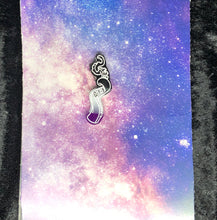 Load image into Gallery viewer, a coiled tentacle earring with ace pride colors (black, grey, white, purple) with bright white highlights on a pink-and-blue nebula and black crushed velvet background