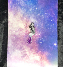 Load image into Gallery viewer, a coiled tentacle earring with ace pride colors (black, grey, white, purple) with bright white highlights on a pink-and-blue nebula and black crushed velvet background