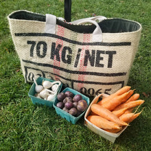 Load image into Gallery viewer, upcycled tote bag with cartons of fresh vegetables in front on bright green grass
