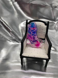 image is a clear high-heeled boot with white and a pink heart. background has black and pink swirls