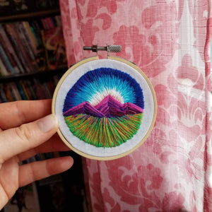 Hand embroidered art hoop of a landscape with mountains for an embroidery gift
