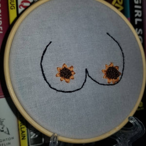 Hand embroidered sunflowers and large boobs art hoop