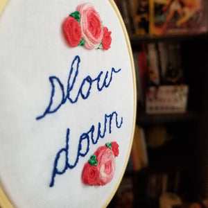 Hand embroidered modern art hoop with roses and a reminder to relax and slow down to help reduce anxiety and stress