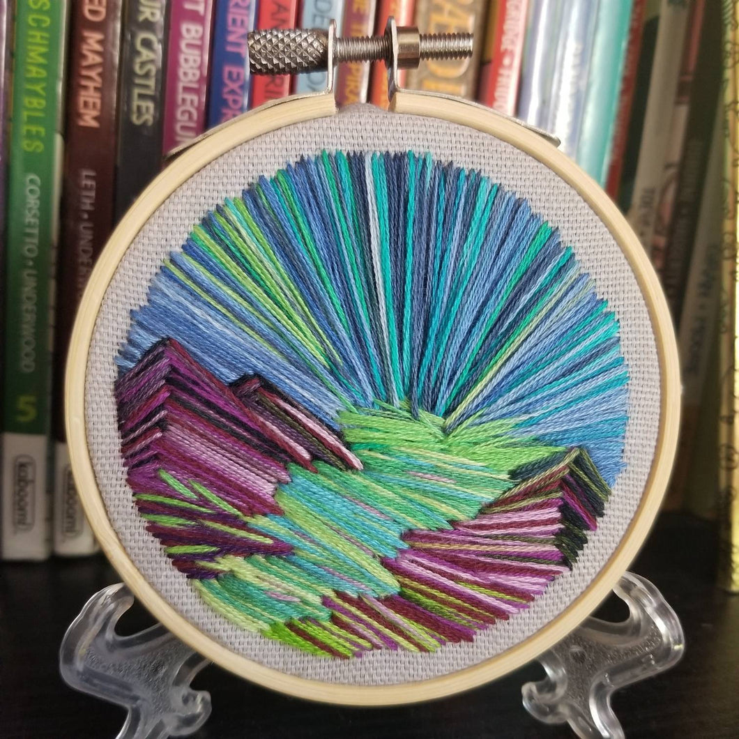 Landscape embroidery with mountains