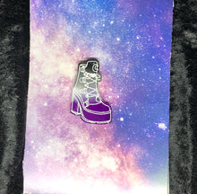 Load image into Gallery viewer, an Asexual Pride (black to grey to white to purple) broomrider boot earring with bright white highlights. In the background is a nebula and a black crushed velvet border.
