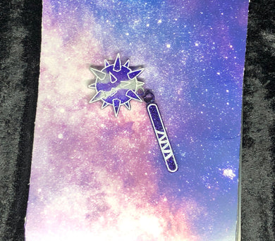 spiked flail earring with sparkly purple and silver swirls and bright white outlines against a pink-and-blue nebula and black crushed velvet background