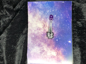 ace pride flag (black, gray, white, purple) spiked baseball bat earring with bright white outlines against a pink-and-blue nebula and black crushed velvet background