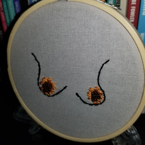 Hand embroidered sunflowers and boobs art hoop