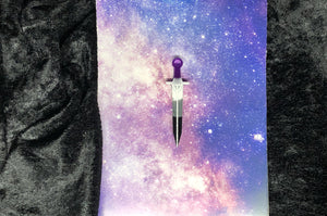 ace pride flag (black, gray, white, purple) long sword earring with bright white outlines against a pink-and-blue nebula and black crushed velvet background