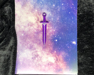 purple long sword earring with bright white outlines against a pink-and-blue nebula and black crushed velvet background