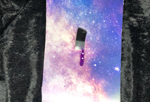 Load image into Gallery viewer, ace pride flag (black, gray, white, purple) butcher cleaver earring with bright white outlines against a pink-and-blue nebula and black crushed velvet background
